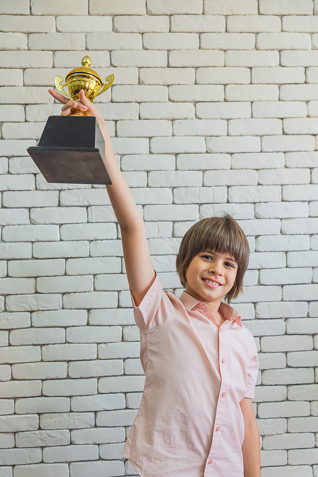International elementary school  boy receiving the Award  trophy